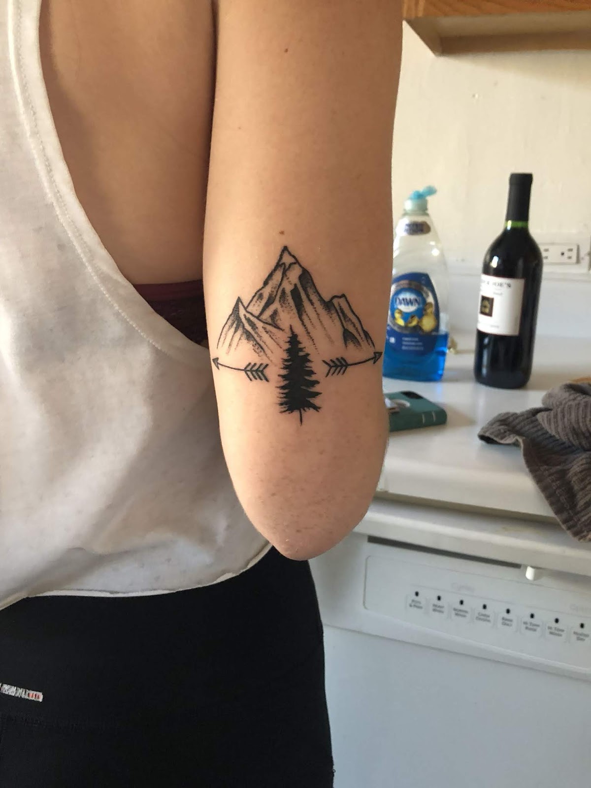 minimalist mountain tattoo on foot