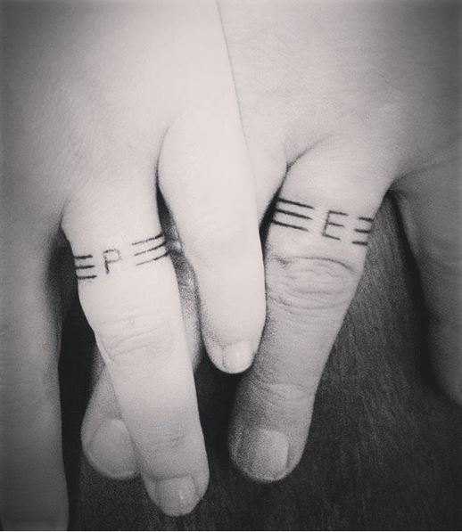 Little Tattoos — White ink “love” tattoo on the right ring finger....