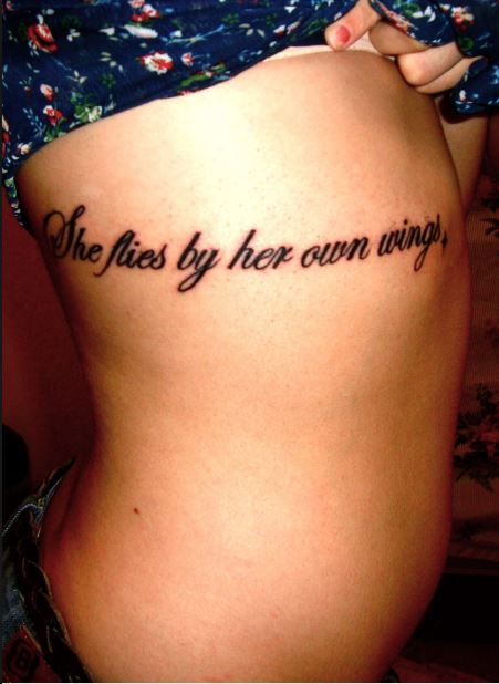 Feminine Quote Tattoo On Girl Side Rib